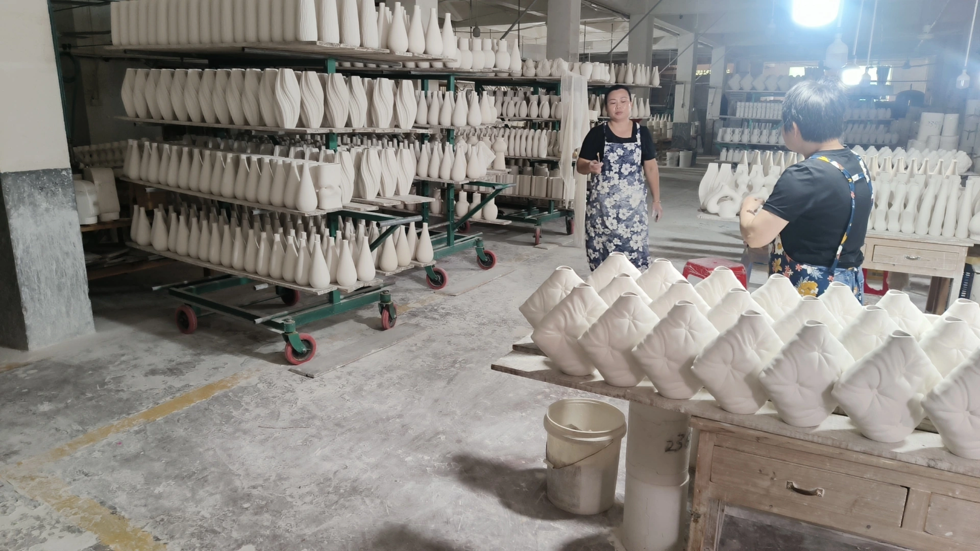Dehua ceramic production workshop — unfinished porcelain vases on drying racks