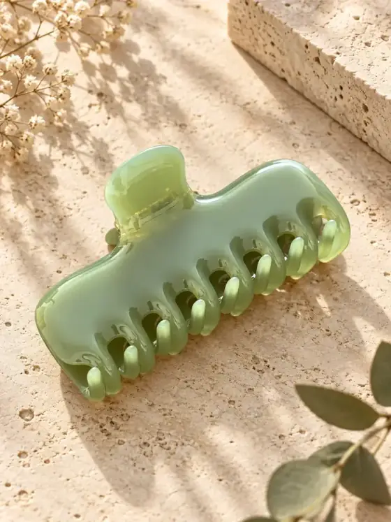 Acetate hair claw — polished accessory still life