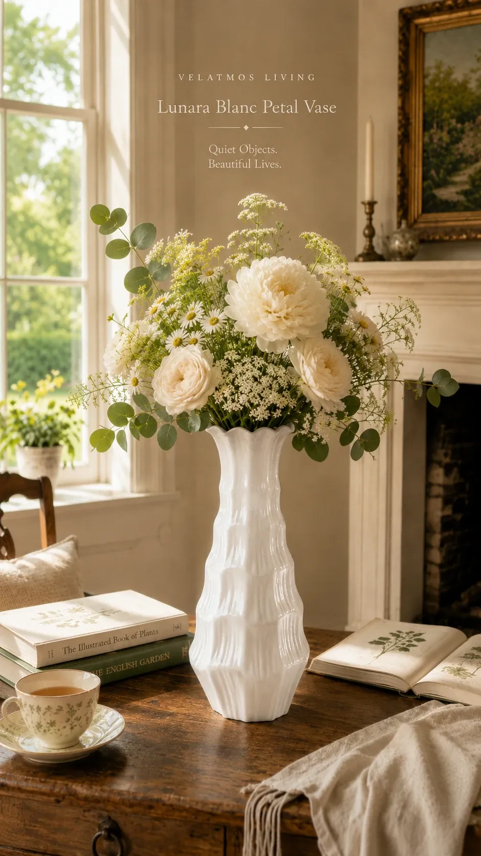 Lunara Blanc Petal Vase with white peonies and eucalyptus on a dark wood table by a fireplace — botanical books and tea