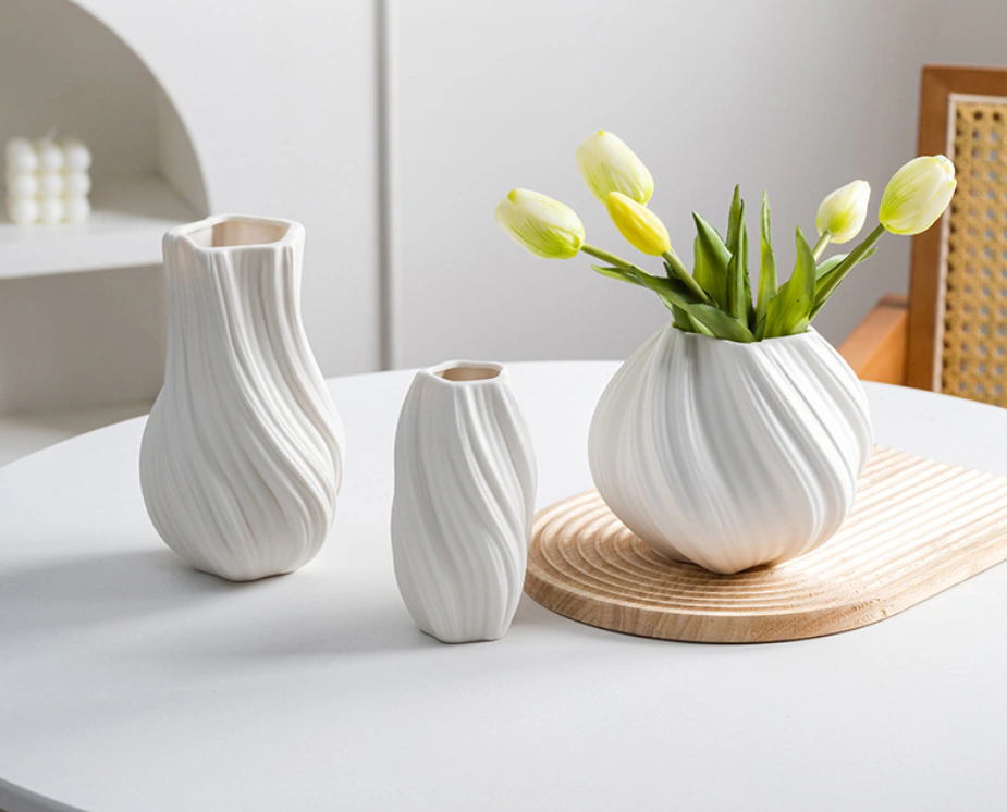 Studio photograph of the Lunara Flow collection with the orb vase